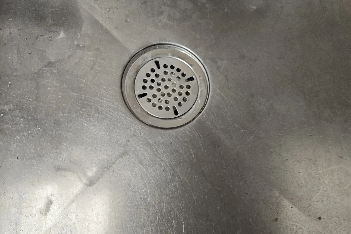 New drain strainer in a stainless steel sink
