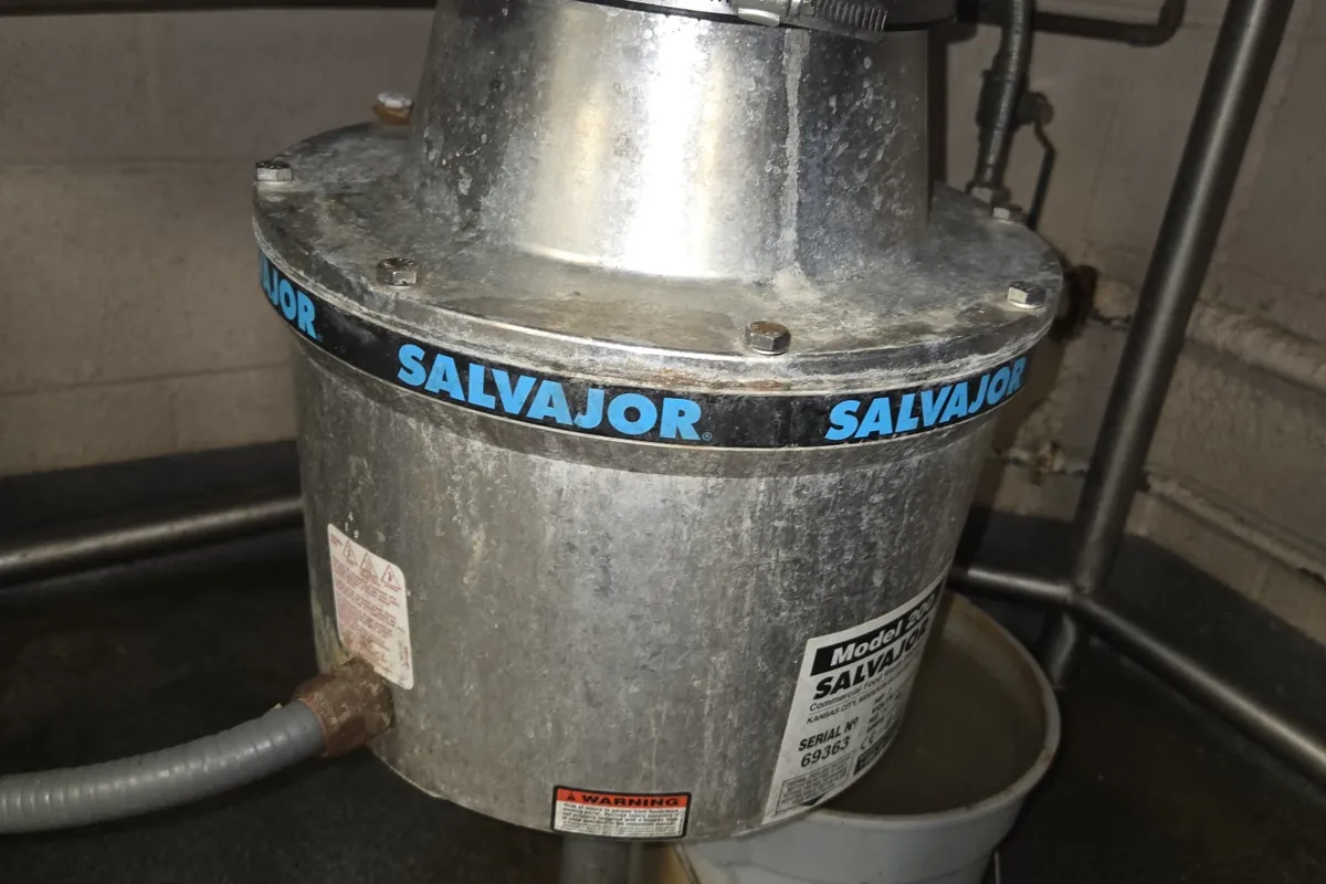 Commercial disposal mounted under a stainless sink