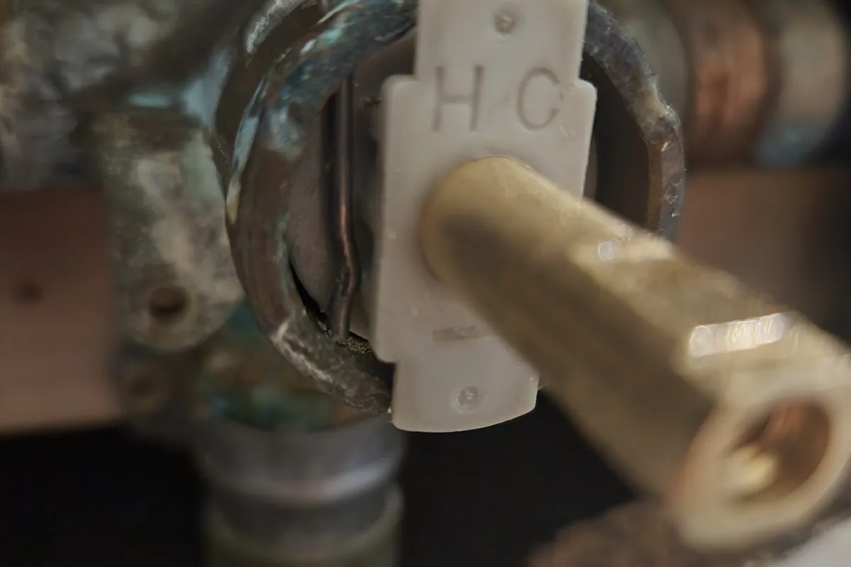 Shower valve cartridge being replaced in the wall