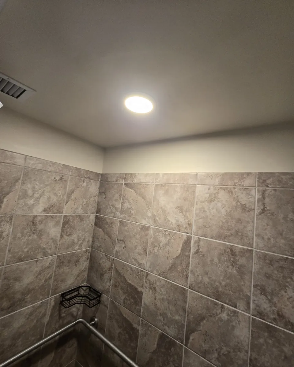 Tiled shower room with a new ceiling light