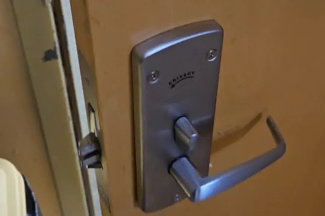 Commercial lever handle lock installed on a wood door