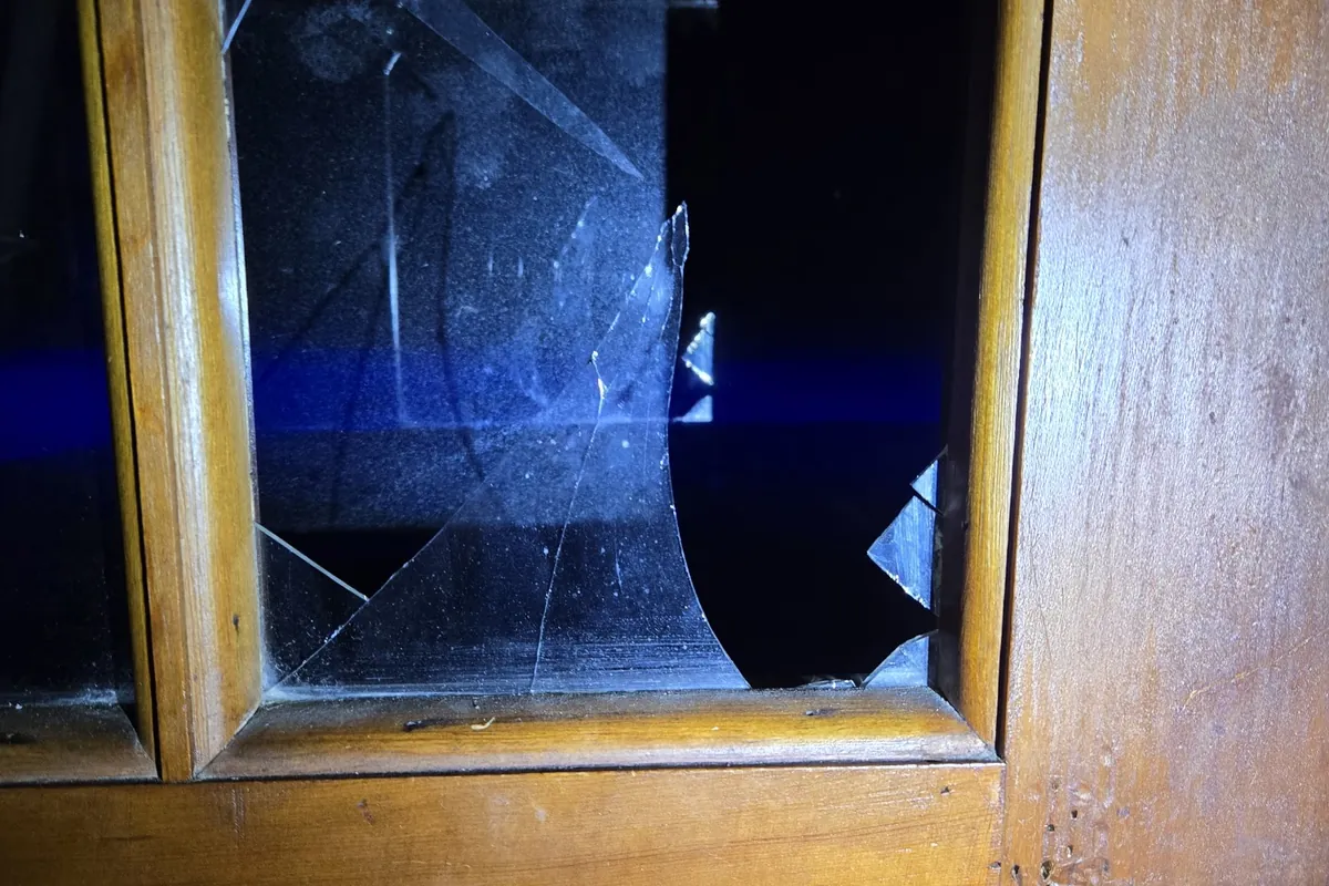 Cracked glass pane in a wood exterior door, before repair