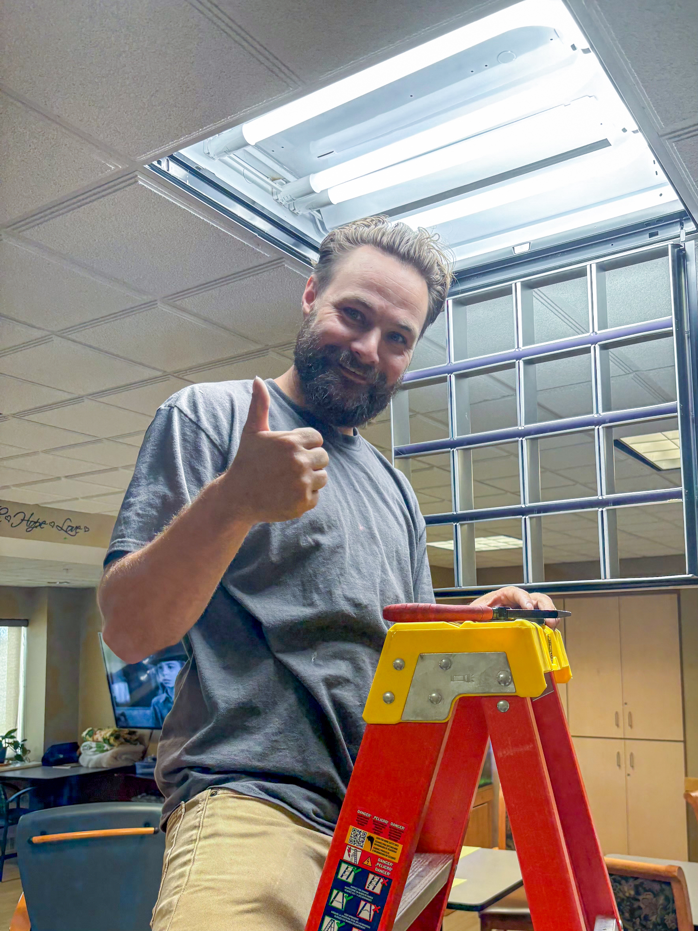 Justin replacing office ceiling light fixture