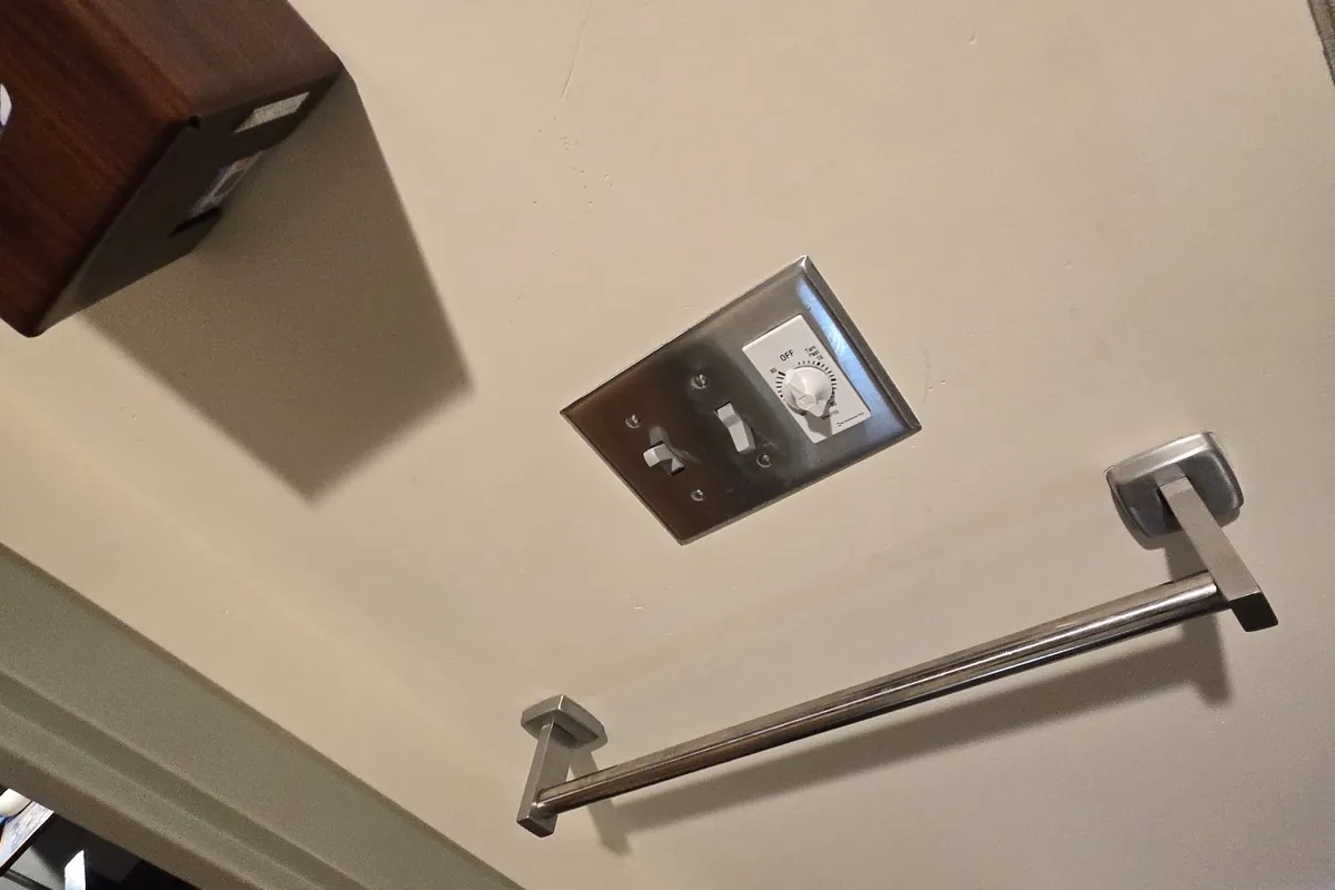 New chrome towel bar mounted on a bathroom wall